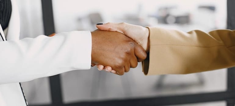 Two people shaking hands after discussing Dubai and global trade opportunities it offers